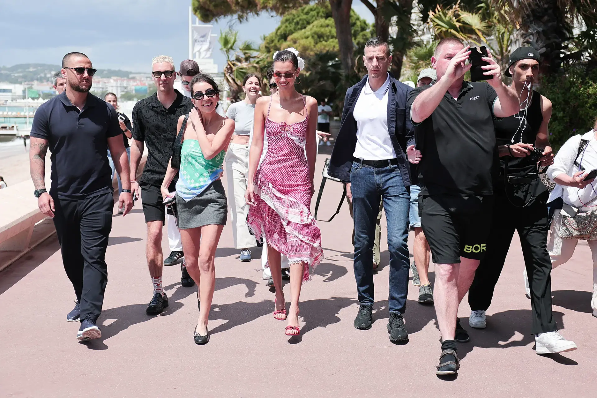 Bella Hadid (center) is seen wearing a keffiyeh-inspired dress by Michael and Hushi during the 77th Cannes Film Festival on May 23, 2024. Jacopo Raule
