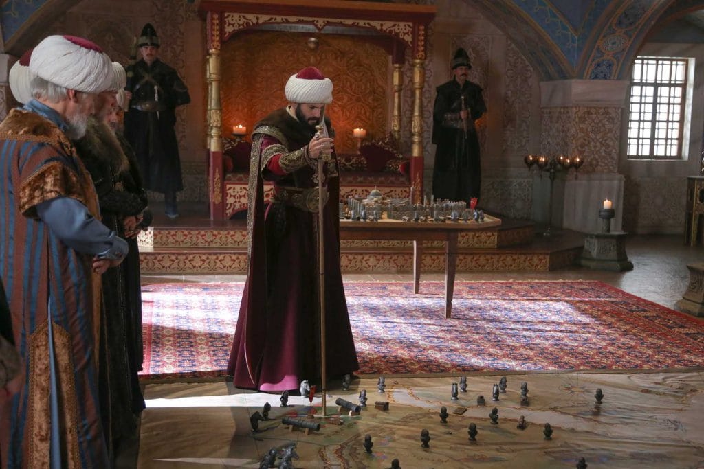 Mehmed preparing for the siege of Constantinople – An image of Sultan Mehmed II standing in front of a map, strategizing the conquest of Constantinople.