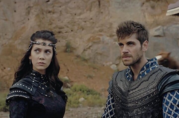 Emre Bey as Orhan Bey in Kuruluş Osman; Ecem Sena Bayır as Nilüfer Hatun in costume during a dramatic farewell scene.

