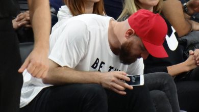 Elçin Sangu sitting in the audience at a basketball game