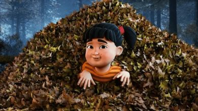 Animated film still of a girl with black pigtails and an orange striped top emerging from a large pile of autumn leaves in a forest