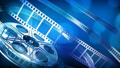 Film reel and strips of film on a blue background, illustrating cinema releases