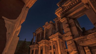 Illuminated ancient ruins of Ephesus at night with candles on the ground